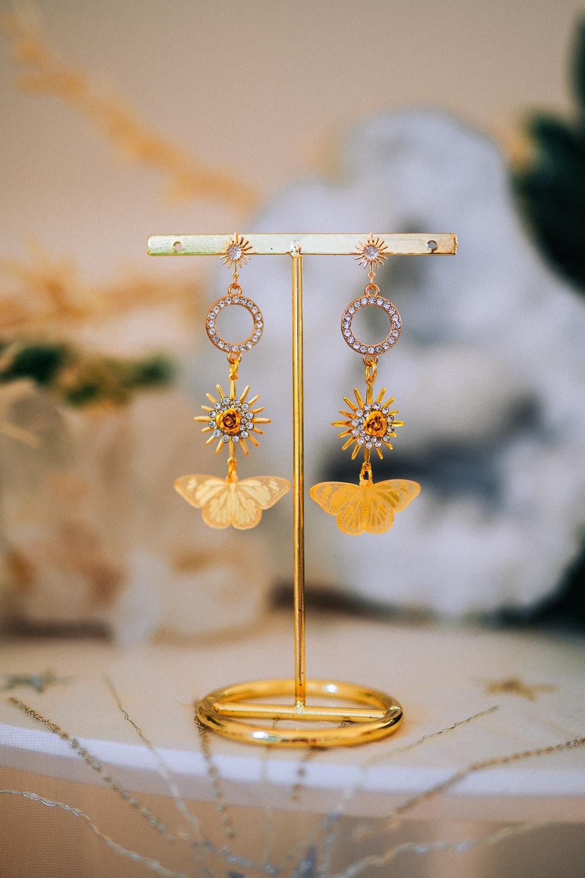 Gold Sun Drop Earrings with Crystal Butterfly Details – Celestial Statement Jewelry