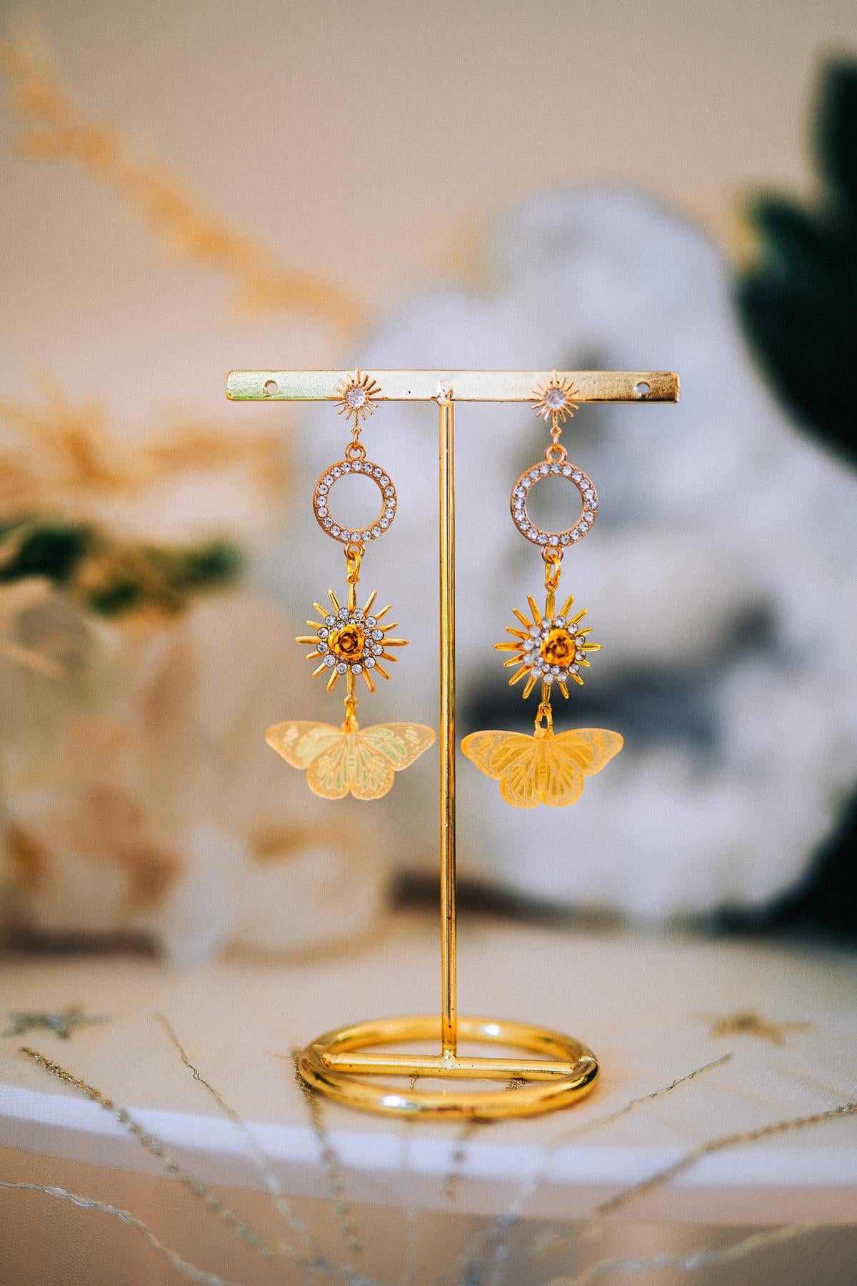 Gold Sun Drop Earrings with Crystal Butterfly Details – Celestial Statement Jewelry