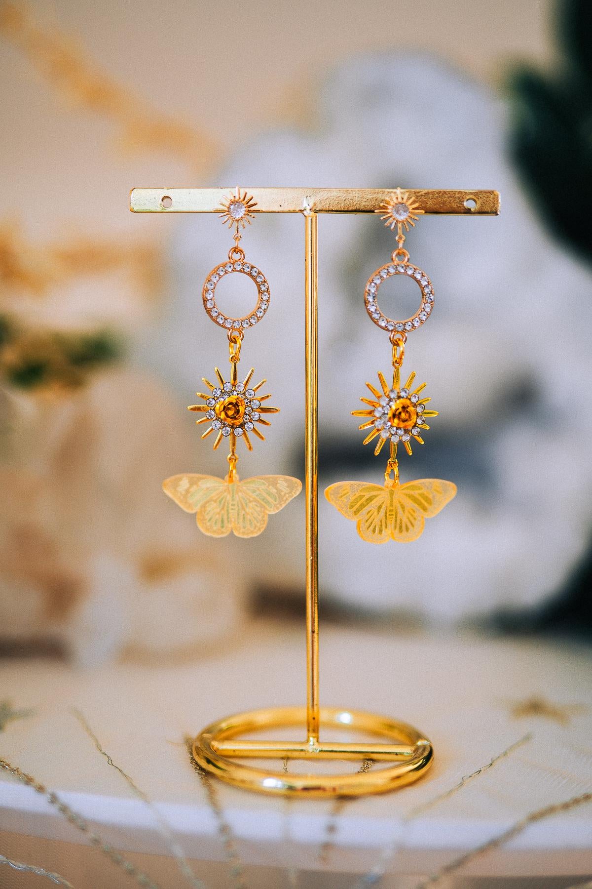 Gold Sun Drop Earrings with Crystal Butterfly Details – Celestial Statement Jewelry