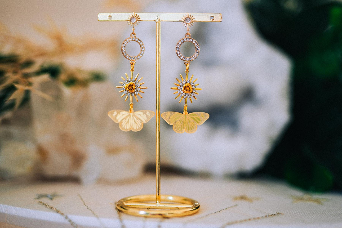Gold Sun Drop Earrings with Crystal Butterfly Details – Celestial Statement Jewelry