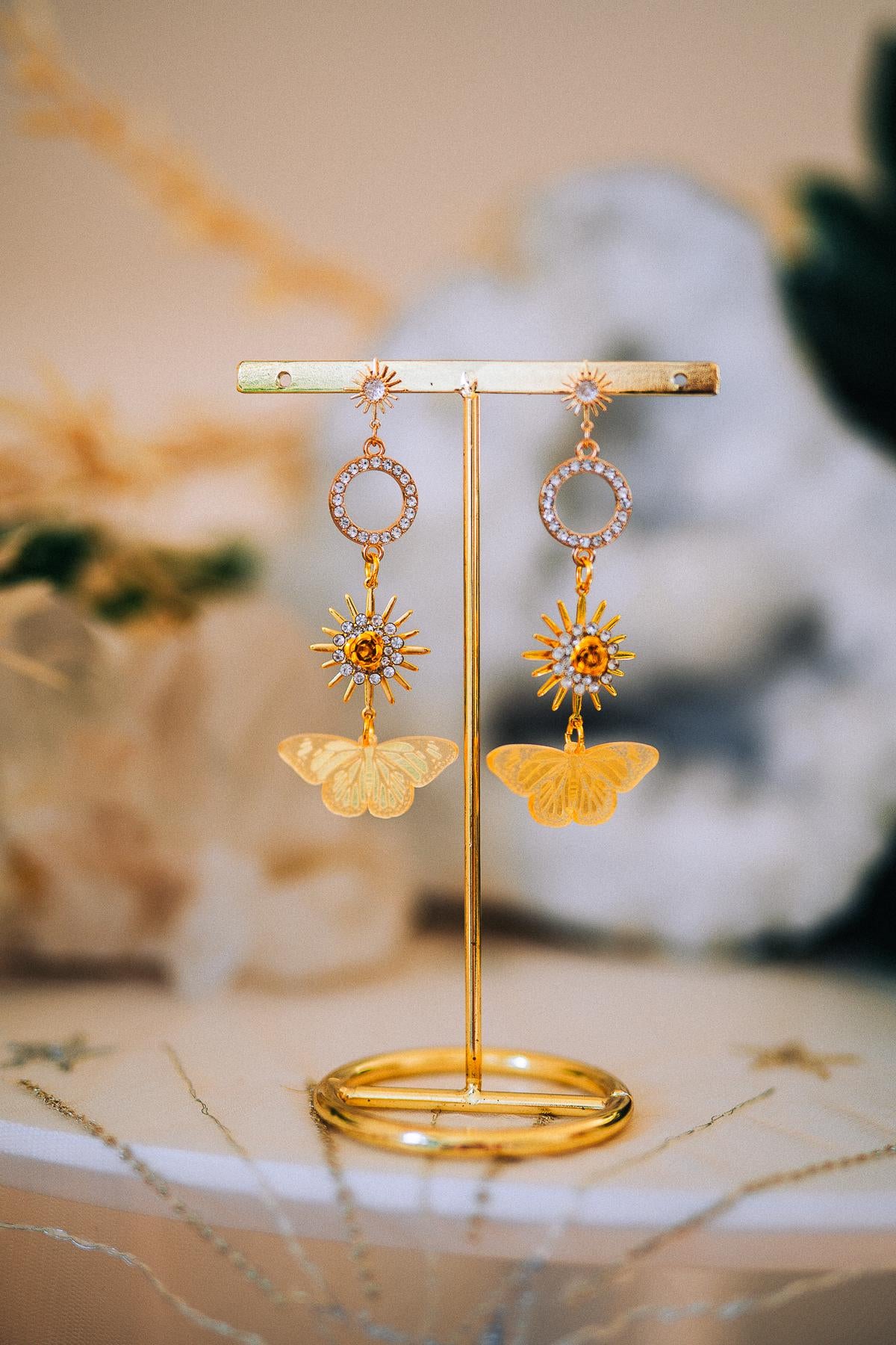 Gold Sun Drop Earrings with Crystal Butterfly Details – Celestial Statement Jewelry