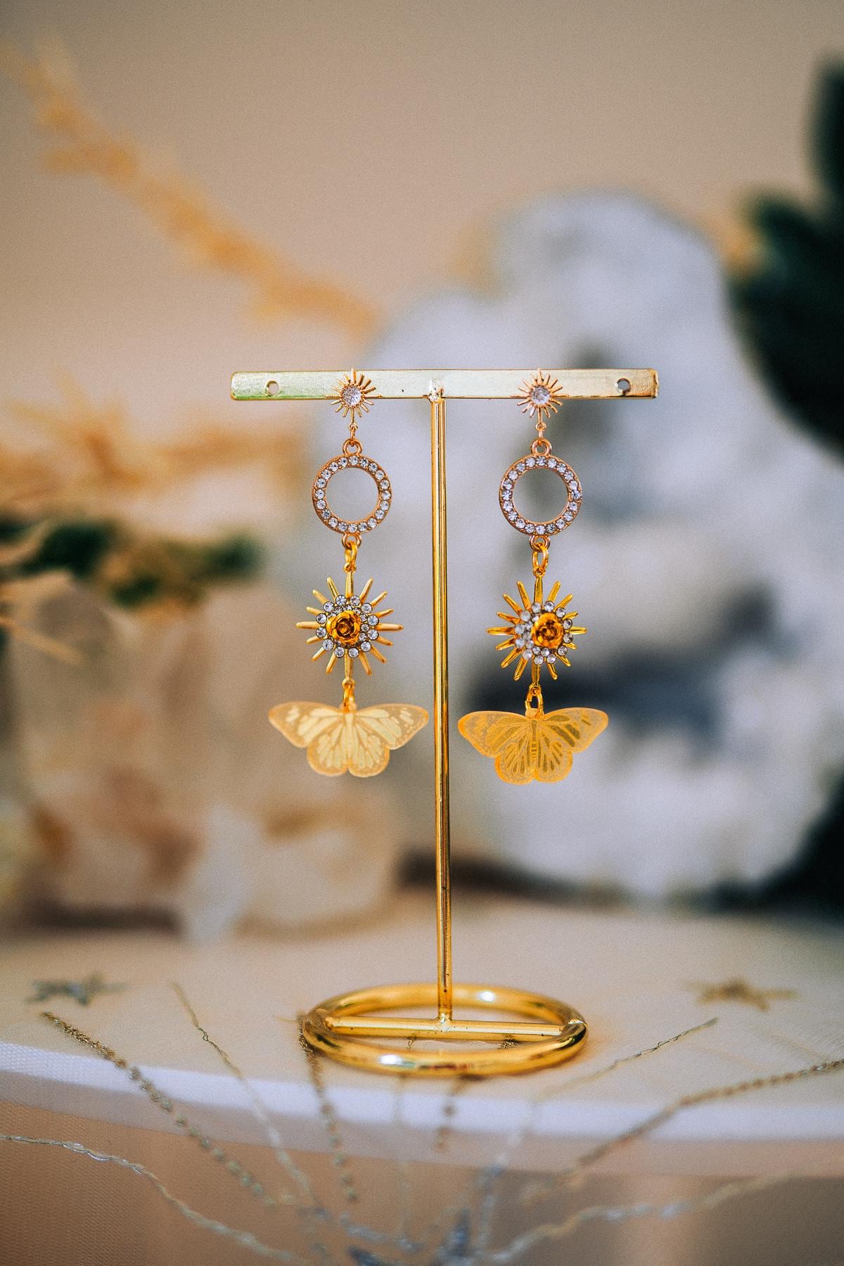 Gold Sun Drop Earrings with Crystal Butterfly Details – Celestial Statement Jewelry