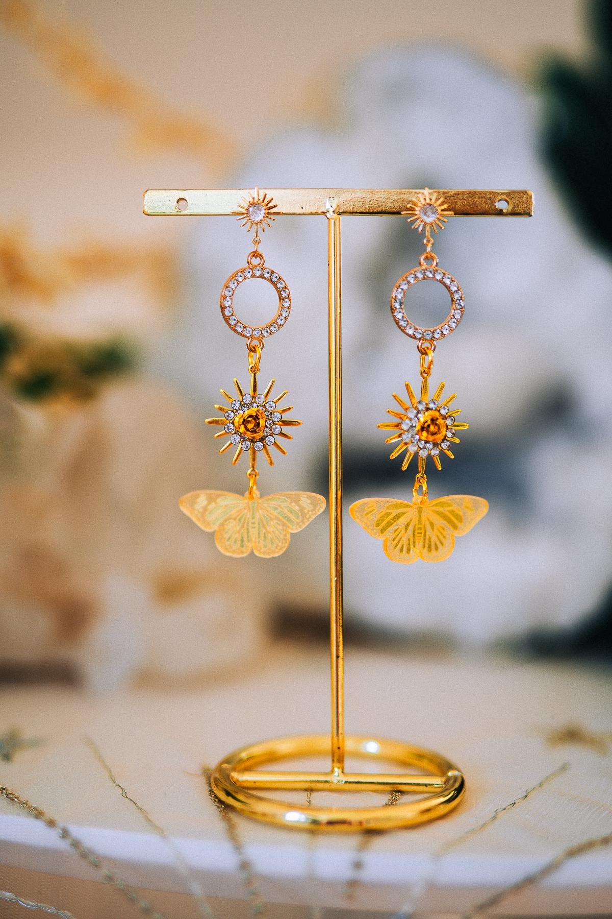Gold Sun Drop Earrings with Crystal Butterfly Details – Celestial Statement Jewelry