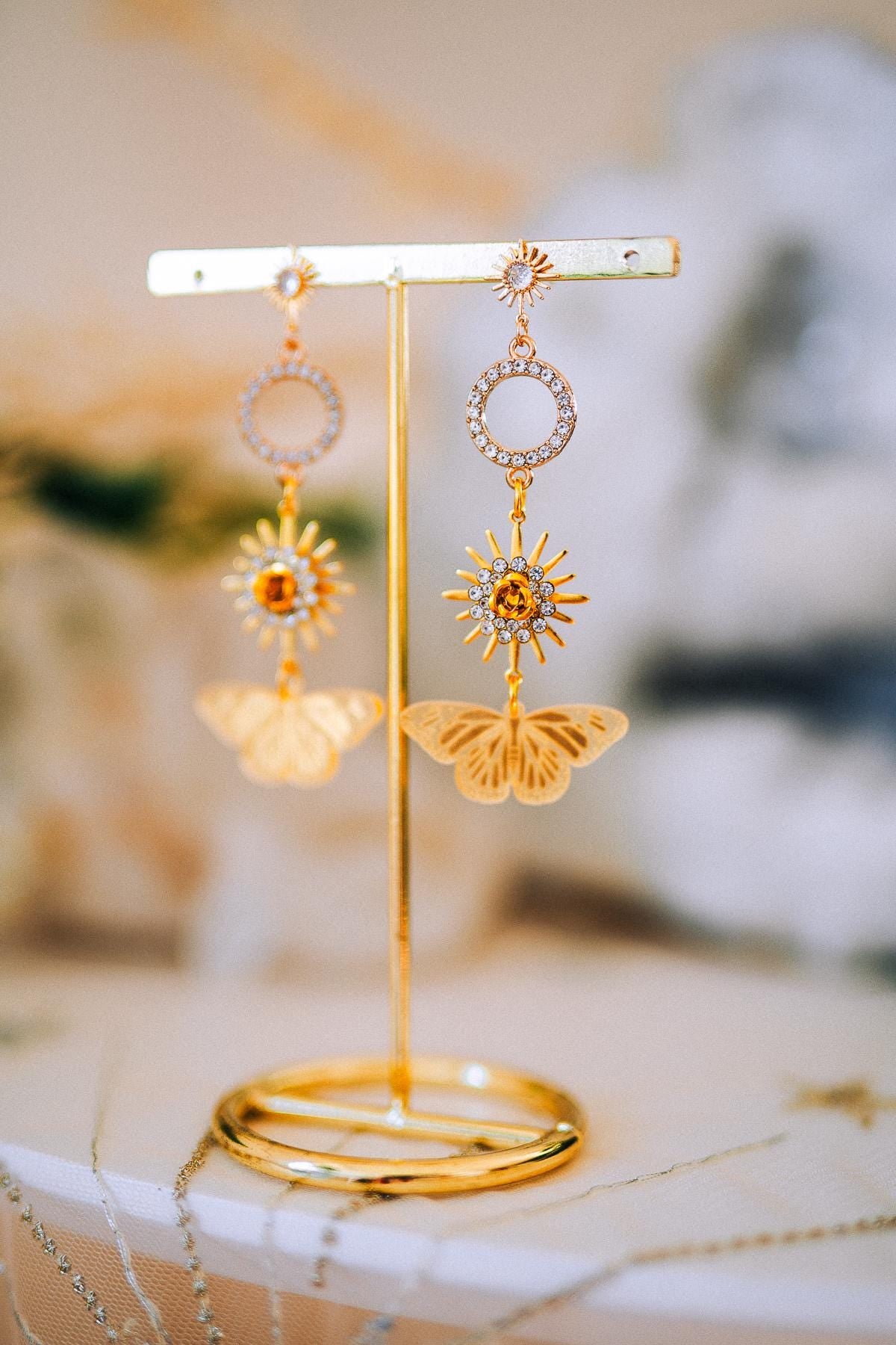 Gold Sun Drop Earrings with Crystal Butterfly Details – Celestial Statement Jewelry