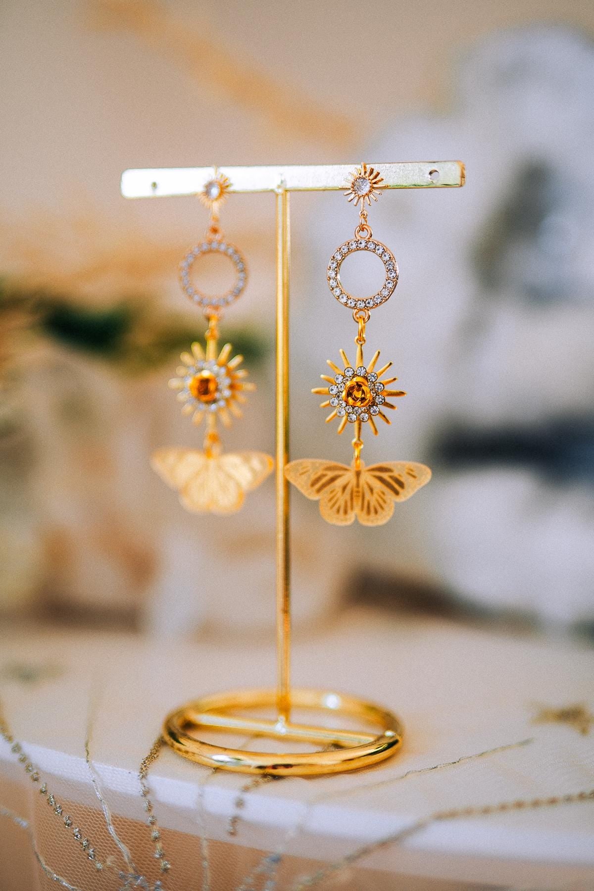 Gold Sun Drop Earrings with Crystal Butterfly Details – Celestial Statement Jewelry