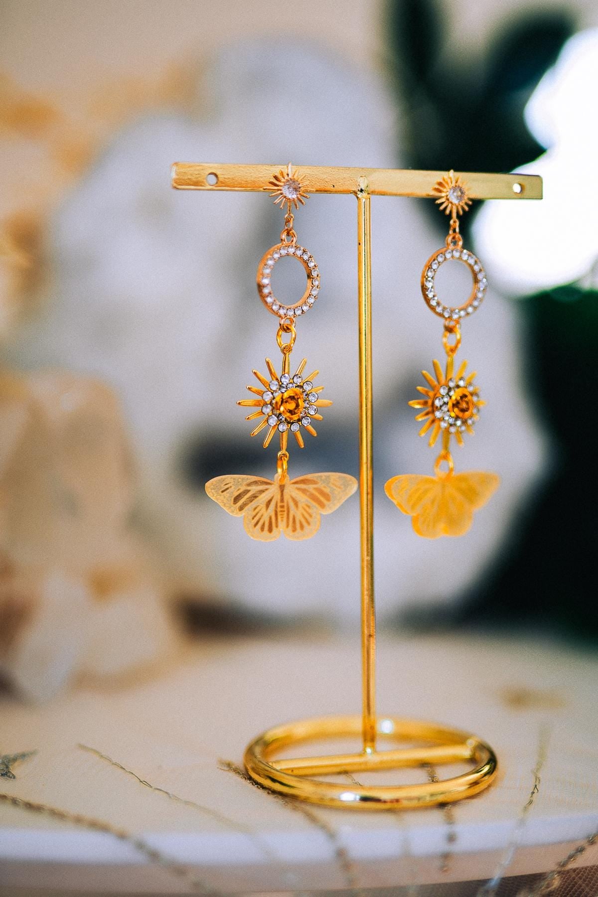 Gold Sun Drop Earrings with Crystal Butterfly Details – Celestial Statement Jewelry