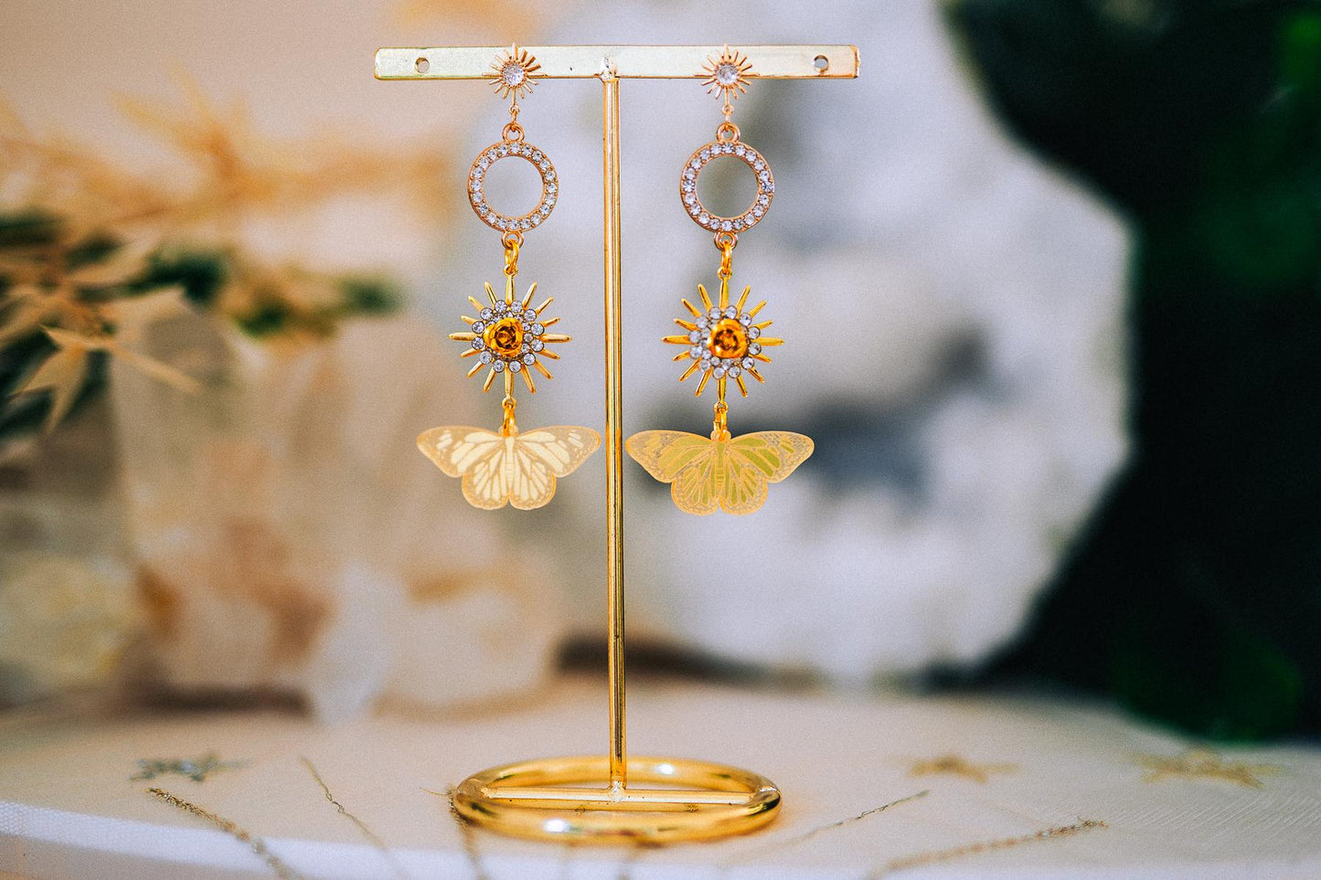 Gold Sun Drop Earrings with Crystal Butterfly Details – Celestial Statement Jewelry