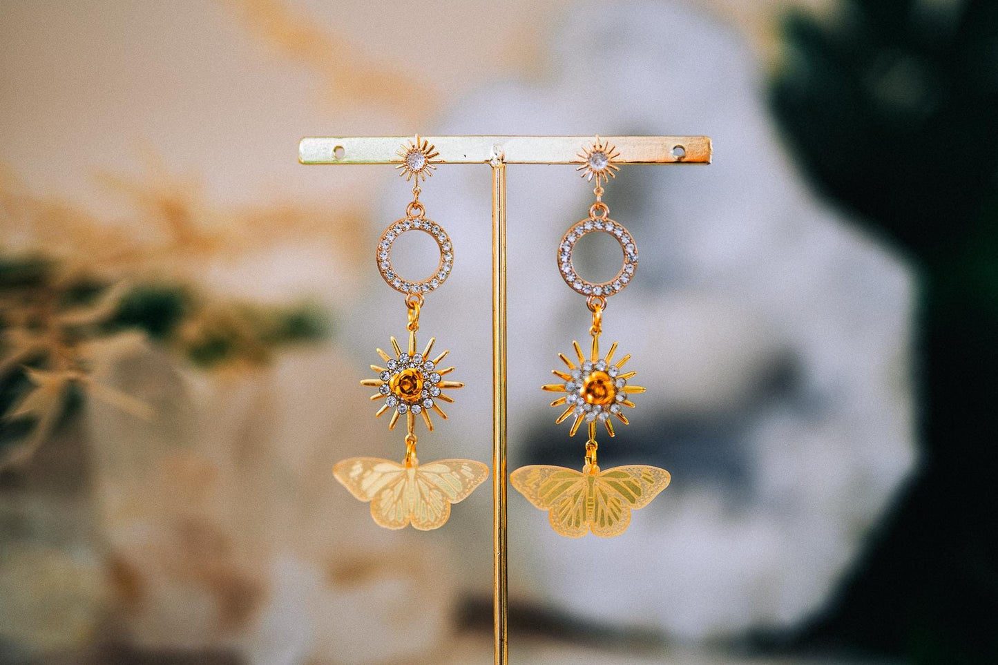 Gold Sun Drop Earrings with Crystal Butterfly Details – Celestial Statement Jewelry