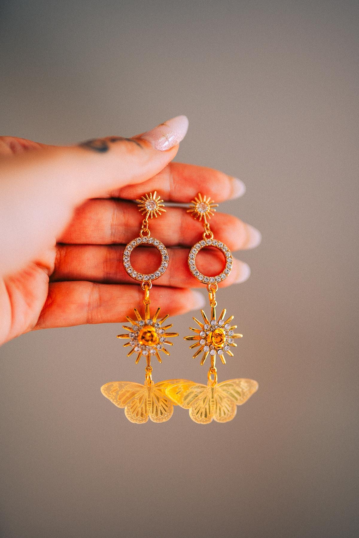 Gold Sun Drop Earrings with Crystal Butterfly Details – Celestial Statement Jewelry